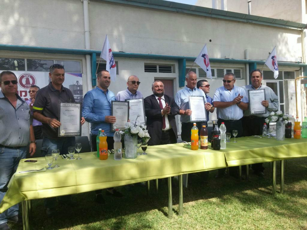 תמונה קבוצתית של בכירי העירייה עם מנהלי המפעל החדשים